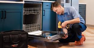 Technician repairing a built-in dishwasher in a clean kitchen